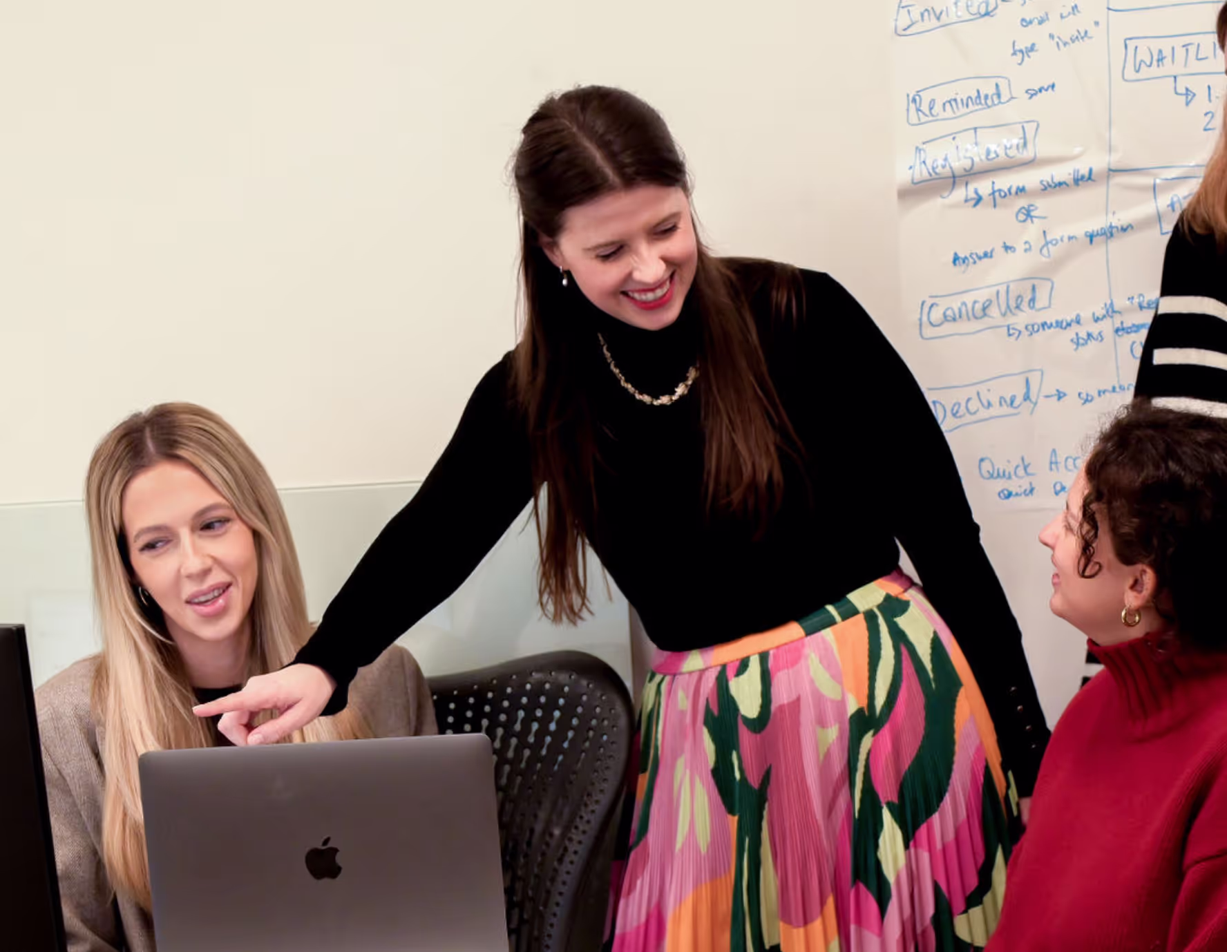 The team working through registration statuses at a laptop